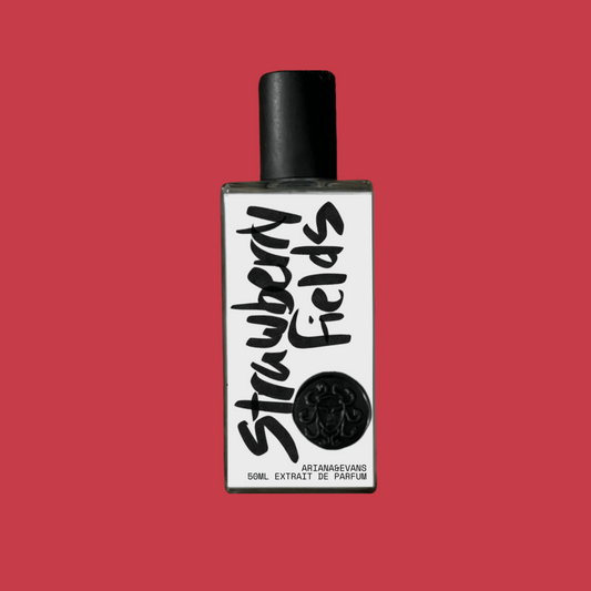 Perfume bottle labeled 'Strawberry Fields' on a red background. Niche Fragrances