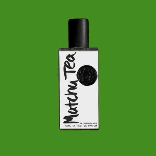 Matcha Tea fragrance presented in a glass bottle with green background. 