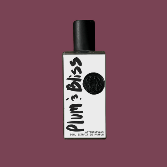 Perfume bottle labeled 'Plum & Bliss' on a solid light plum color background. 50ml  glass bottle. Best Niche Fragrances